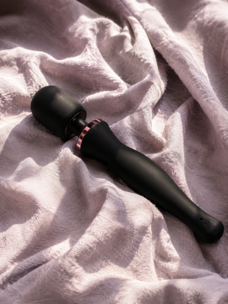 Esmerelda massager resting on blush linen