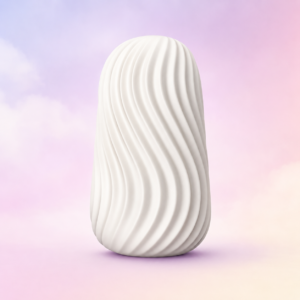 White textured Jizzu stroker standing upright against a soft pink, lavender and cream studio background.