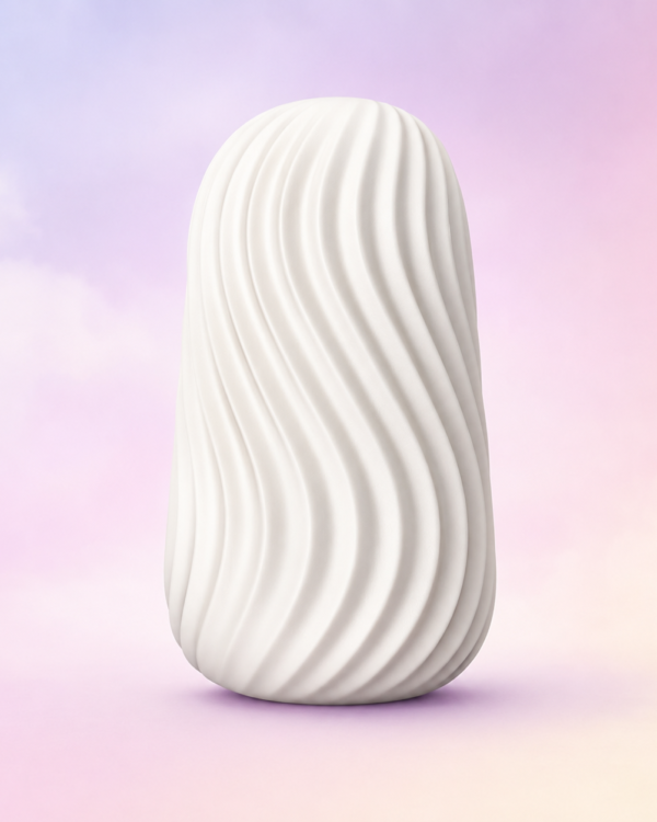 White textured Jizzu stroker standing upright against a soft pink, lavender and cream studio background.