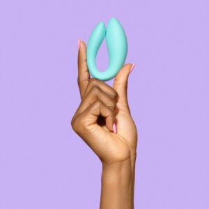 The Larita, a hands-free sex toy with a sleek, ergonomic design, featuring a smaller insertable part for internal stimulation and a larger external part for clitoral stimulation. The toy is flexible, with a smooth, waterproof surface and a remote control for easy operation.