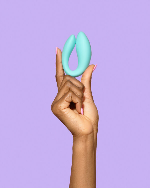 The Larita, a hands-free sex toy with a sleek, ergonomic design, featuring a smaller insertable part for internal stimulation and a larger external part for clitoral stimulation. The toy is flexible, with a smooth, waterproof surface and a remote control for easy operation.